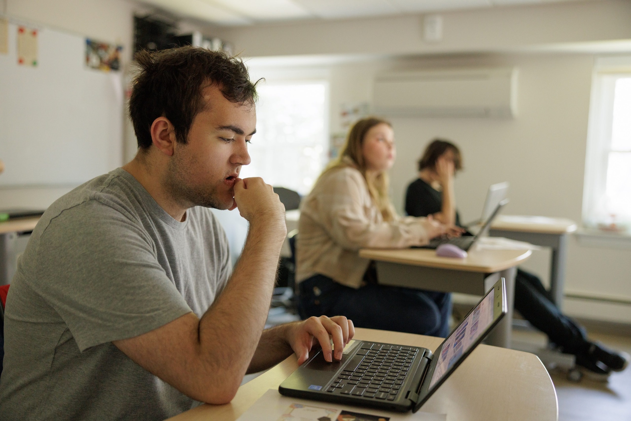 Student focusing at a classroom desk